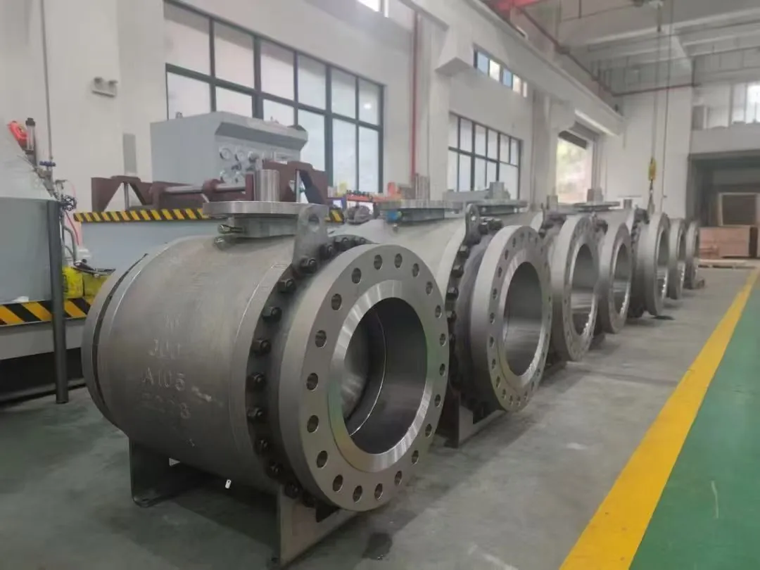 Large flanged industrial ball valves arranged in a production row